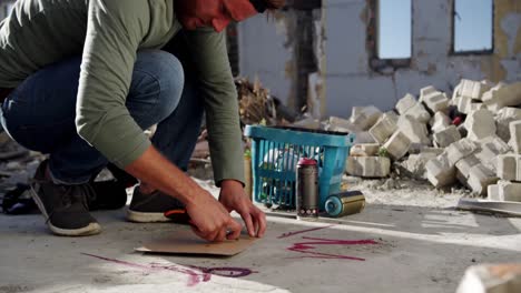 graffiti artist cutting cardboard with cutter 4k