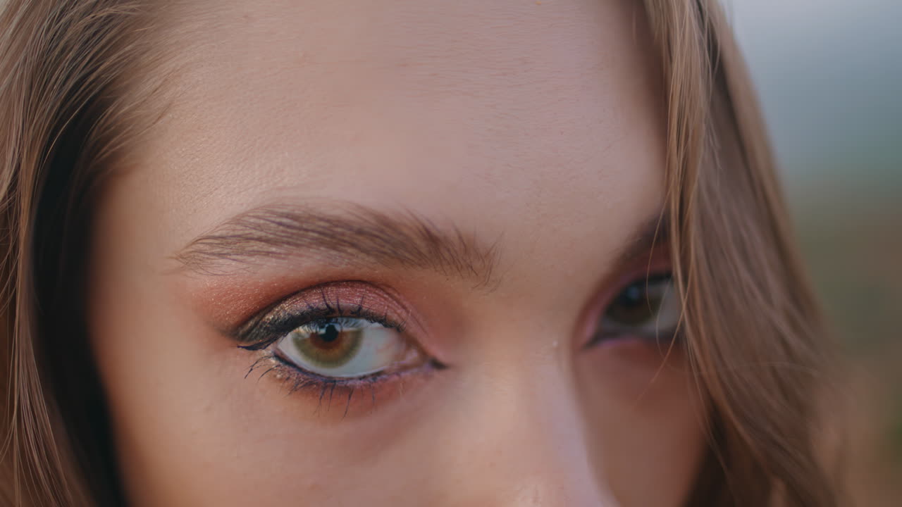 Closeup young woman closed eyes shiny makeup. Green-eyed girl looking camera