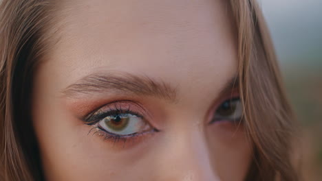 closeup young woman closed eyes shiny makeup. green-eyed girl looking camera