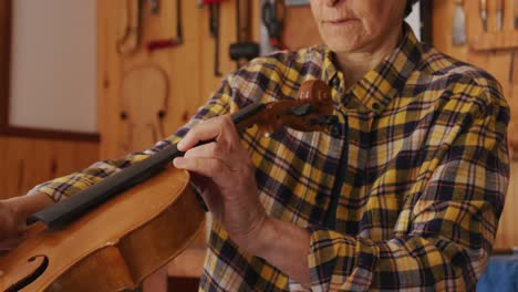 female luthier at work in her workshop