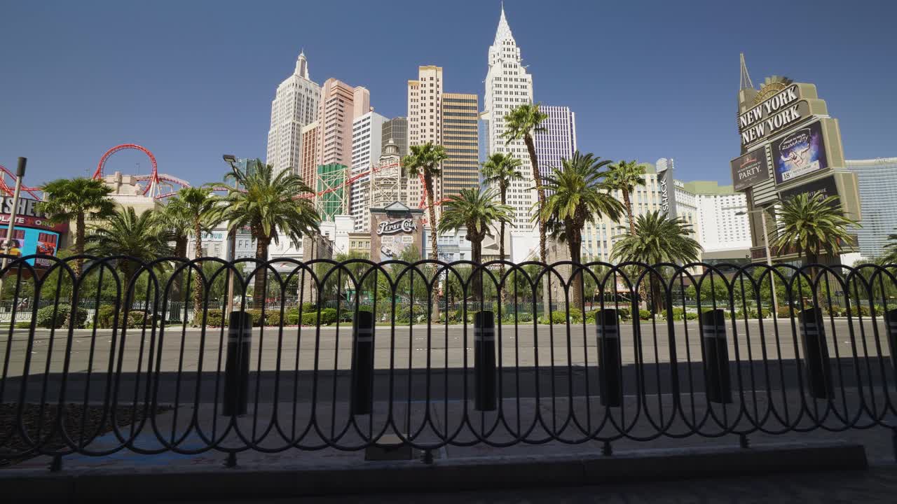 Pedestrian guard rails move in the foreground of the New York New York location on the Las Vegas Strip. The streets remain empty.