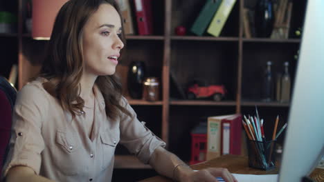 happy business woman checking report on computer