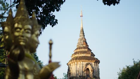 golden statue and pagoda in thailand