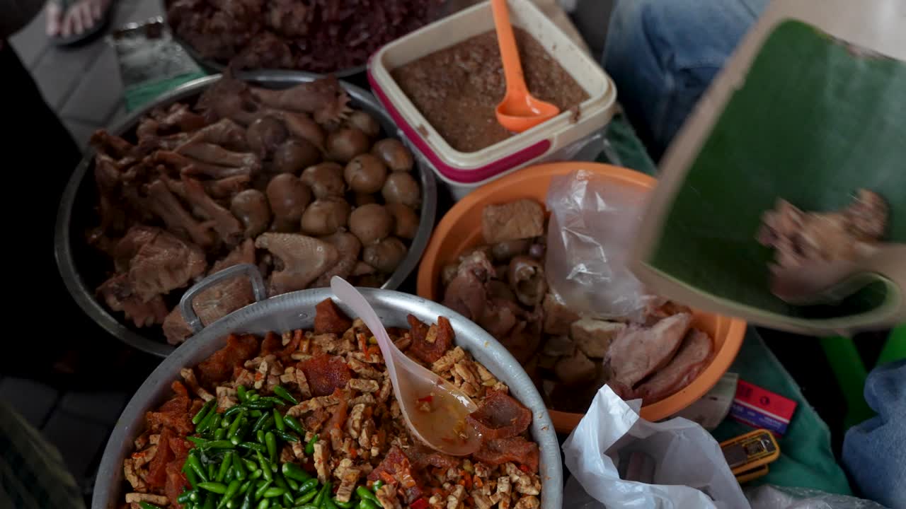 Iconic Nasi Kucing (cat rice) Indonesian street food served up at market stall