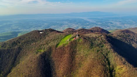 aerial 4k drone footage of a tv and radio communication center on the top of the mountain in the spring time