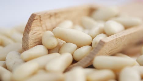 pine nuts in wooden scoop