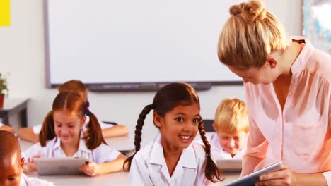 teacher teaching kids on digital tablet