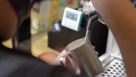 Barista-man-frothed-milk-on-a-coffee-machine-for-making-cappuccino-or-latte