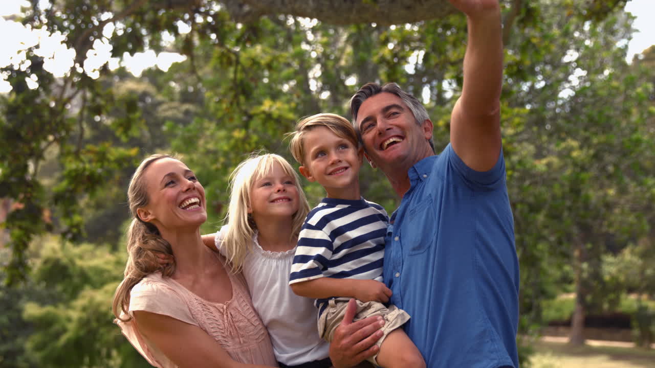 familia feliz tomando una selfie en el parque