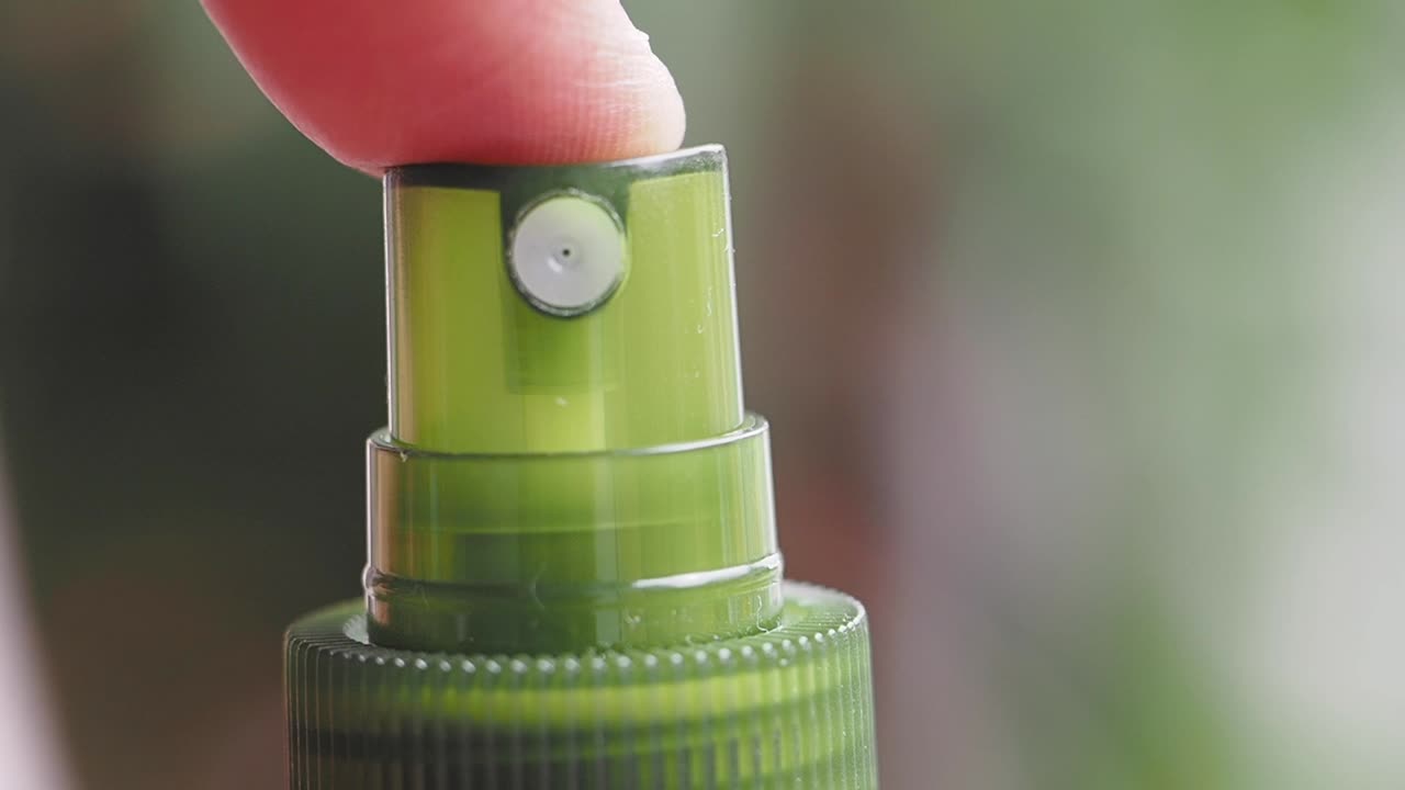 Close-up of a green spray bottle top