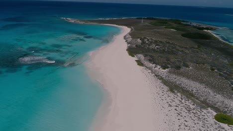 Amazing-tropical-island-with-turquoise-sea-water,-waves-on-shore-beach,-aerial-coastline-scene