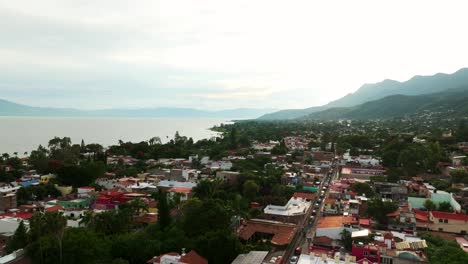 aerial view of ajijic village, lake chapala, jalisco, mexico, at sunset. dolly in drone aerial