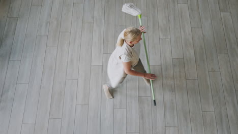 woman sweeping the floor