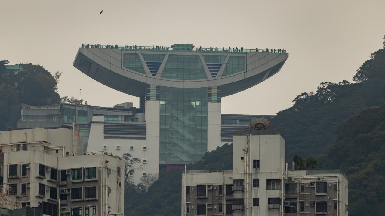 HONG KONG - 19 MARCH 2025 : Timelapse of the Hong Kong city skyline with the peak in the background