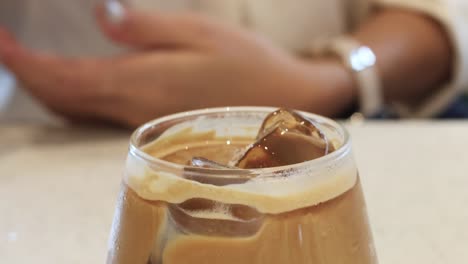 mezclar café helado a mano con una pajita