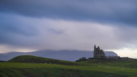 timelapse of classiebawn castle on grassland coastline with moving sunset evening clouds in mullaghmore head in county sligo on the wild atlantic way in ireland