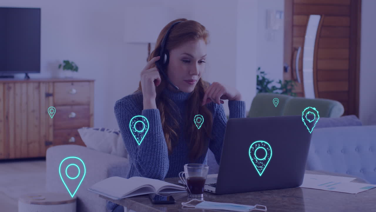Animation of location pin icons over caucasian businesswoman using laptop