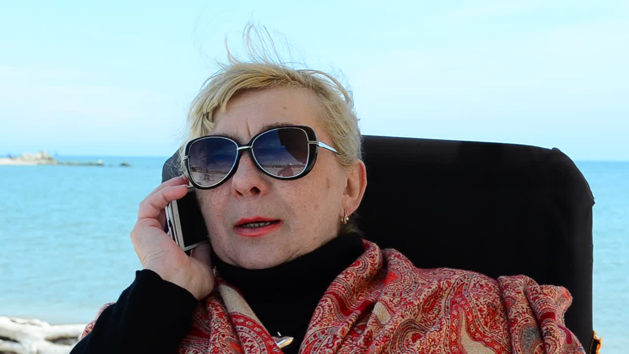Phone conversation. Elderly woman and mobile phone