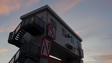 a low-angle shot of the sumida sluice gate building against a beautiful, colorful evening sky