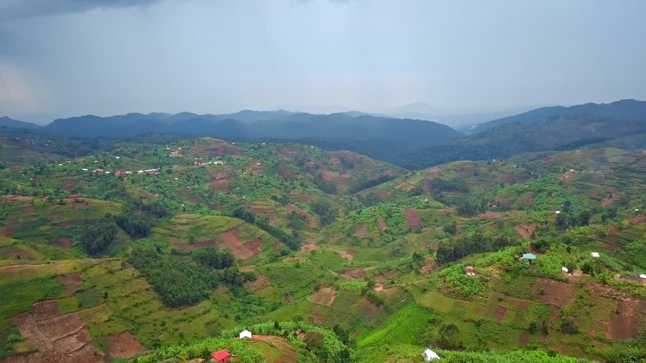 Rural agricultural landscape with terraced farmland and scattered villages in Kanungu District, Western Region, Uganda, near Bwindi Impenetrable National Park, East Africa, aerial drone landscape view