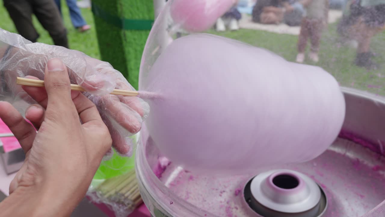 Hand Spinning Pink Sugary Cotton Candy On A Stick.