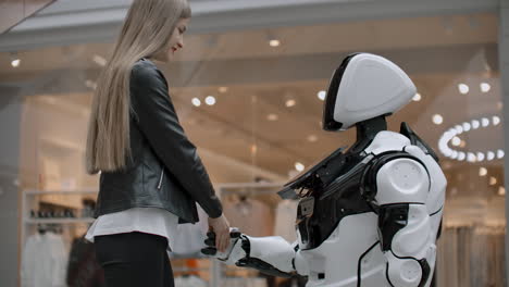 woman smiling shaking hands work. be friends with cyborg. enter into an agreement with the robot