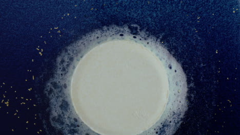 cream circle in bubbles on dark background