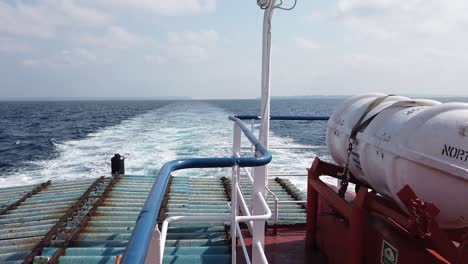 the government ferry in the andaman islands with storage vats and functional parts visible on the bow deck during a sailing between islands