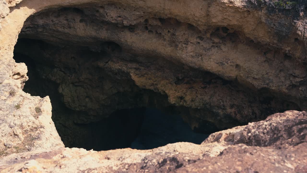 Big Rock Hole In A Cliff Near Ponta da Piedade In Lagos, Portugal. High Angle Shot