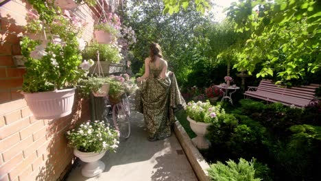 woman in a dress walking through a beautiful garden