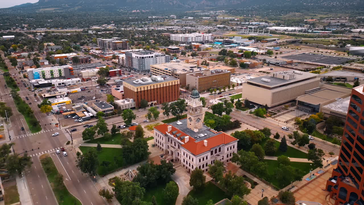 Approaching the building of Colorado Springs Pioneers Museum with a clock tower on top. Vast scenery of the city at backdrop