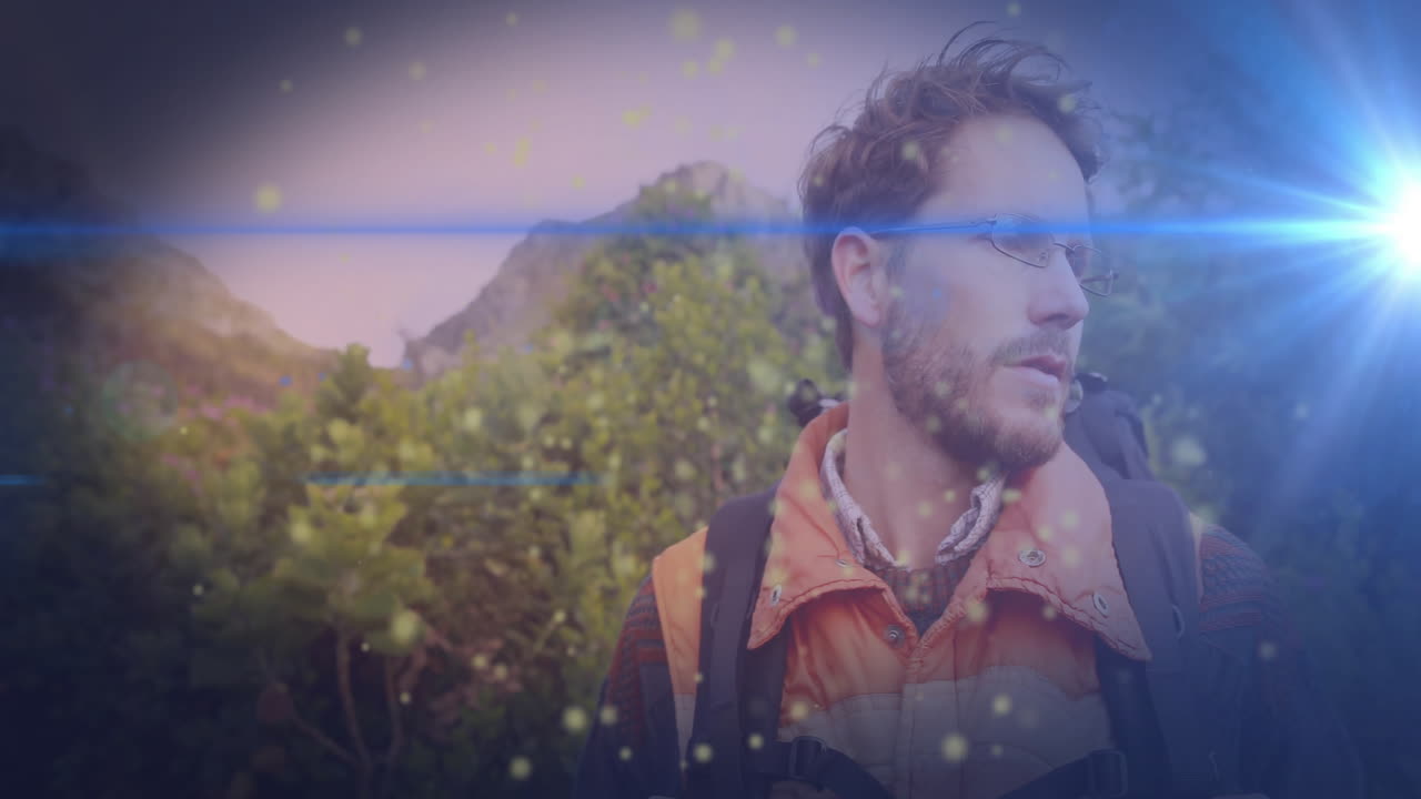 Man hiking mountain trail for travel marketing, with floating light particles overlay
