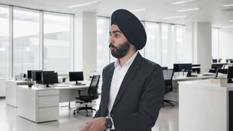 serious sikh indian businessman talking to employees