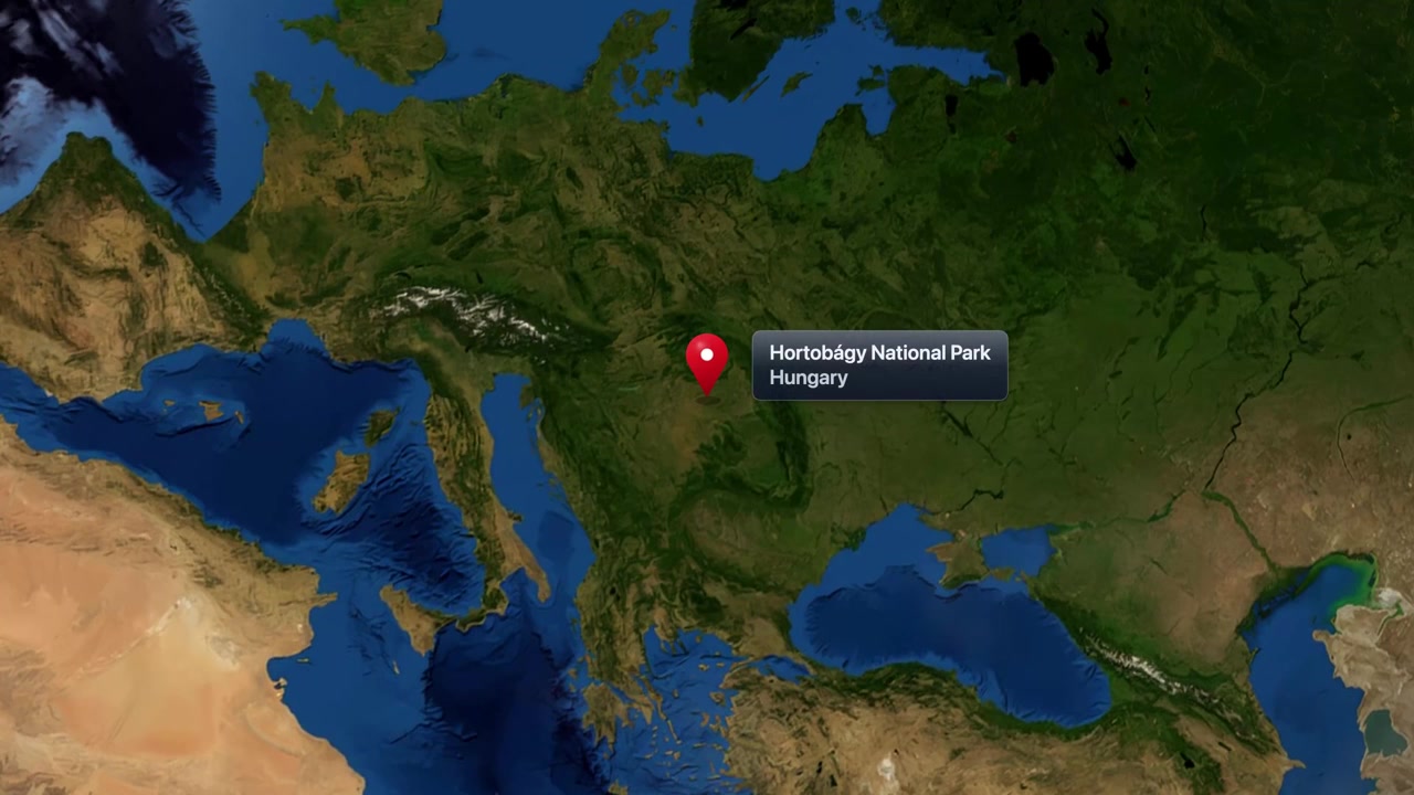 Satellite Earth animation zooming from space into Hortobagy National Park in Hungary with pin. Includes NASA public domain imagery.
