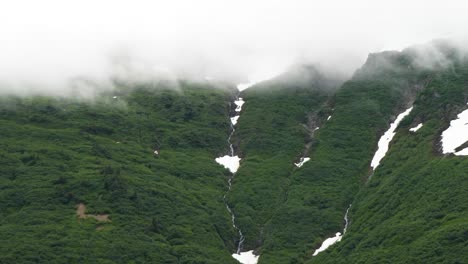 snow capped mountain covered by heavy fog, heading towards juneau, alaska, on gastineau channel.