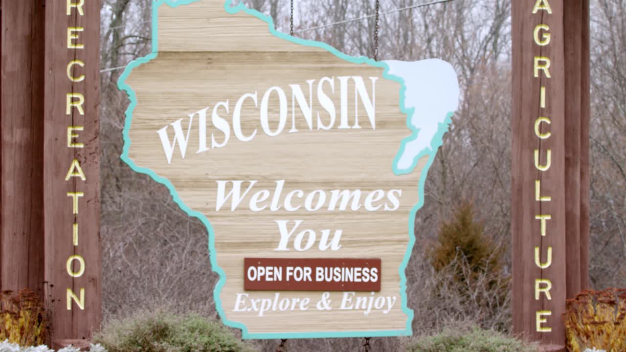 Welcome to Wisconsin Signage shot in close up form, panning right to left at intro to establish.