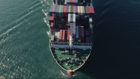 Aerial-top-view-of-a-loaded-container-cargo-vessel-traveling-over-ocean