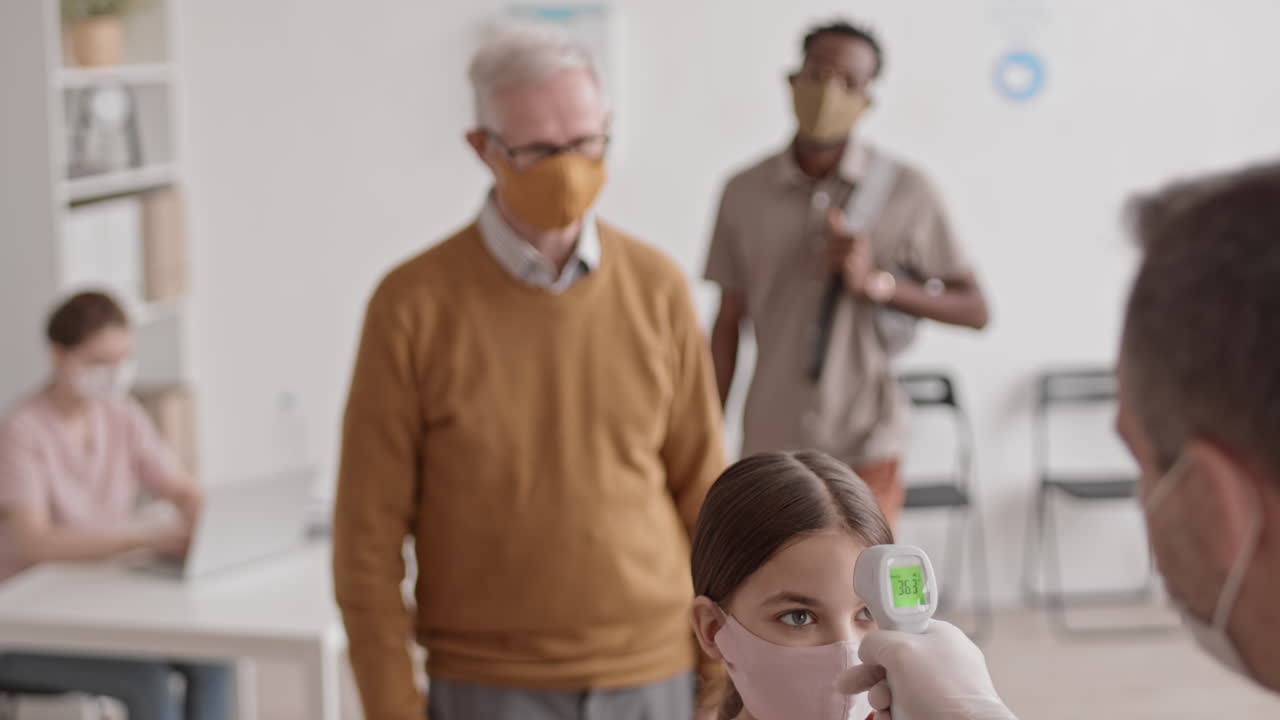 Checking Temperature of Patients with Thermometer