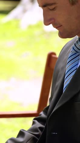 businessman using tablet in the park