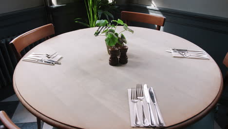 close up of table and chairs set for service in empty restaurant