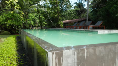 view of an outdoor swimming pool on a private resort in tropical landscape at sri lanka