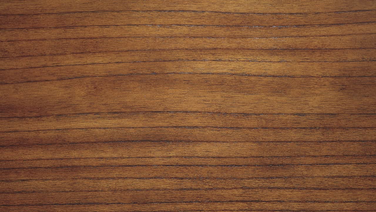 Camera zoom in along dense grain lines of rich timber wood surface