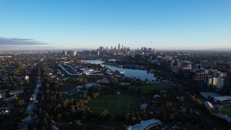 downtown melbourne with skyscrapers skyline during sunrise, aerial backwards