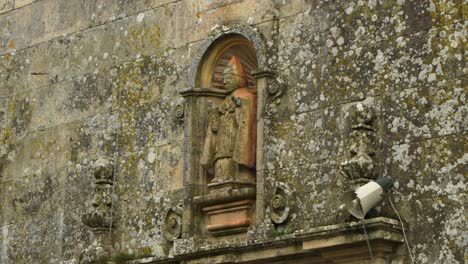 ancient stone statue on church wall
