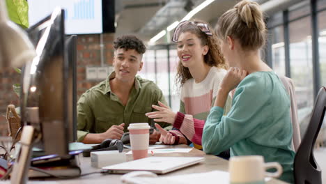 busy diverse business people working on computer and talking in slow motion