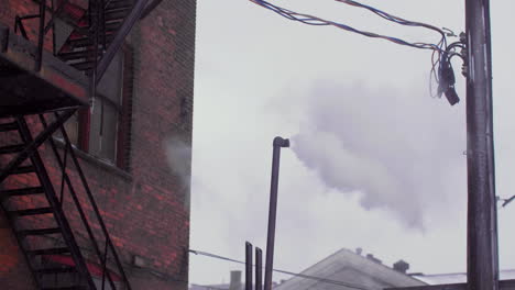Smoke-or-steam-coming-from-tall-thin-metal-pipe