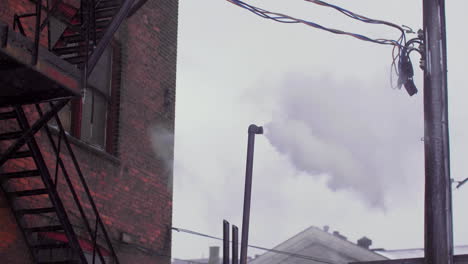 smoke or steam coming from tall thin metal pipe