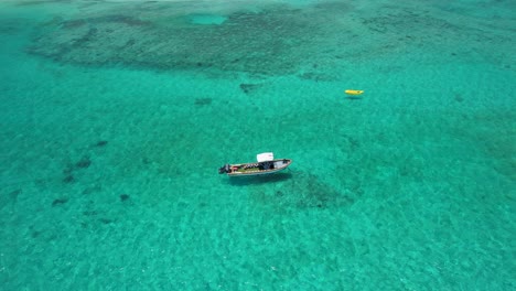 Aerial-pan-of-boats-anchored-in-clear-blue-tropical-water