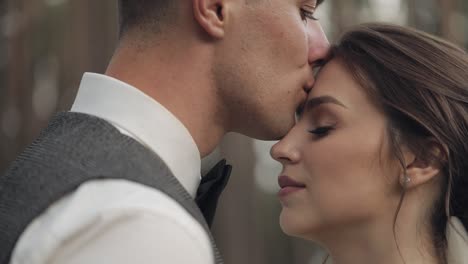 newlyweds, caucasian groom with bride walking, embracing, hugs in park, wedding couple