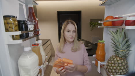 A-woman-takes-salad-ingredients-from-the-refrigerator.